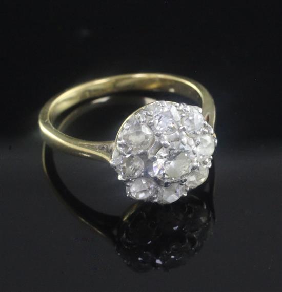 A gold and nine stone diamond cluster ring, size K.